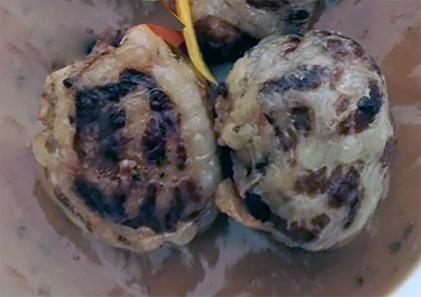 Two fried crépinettes served in gravy