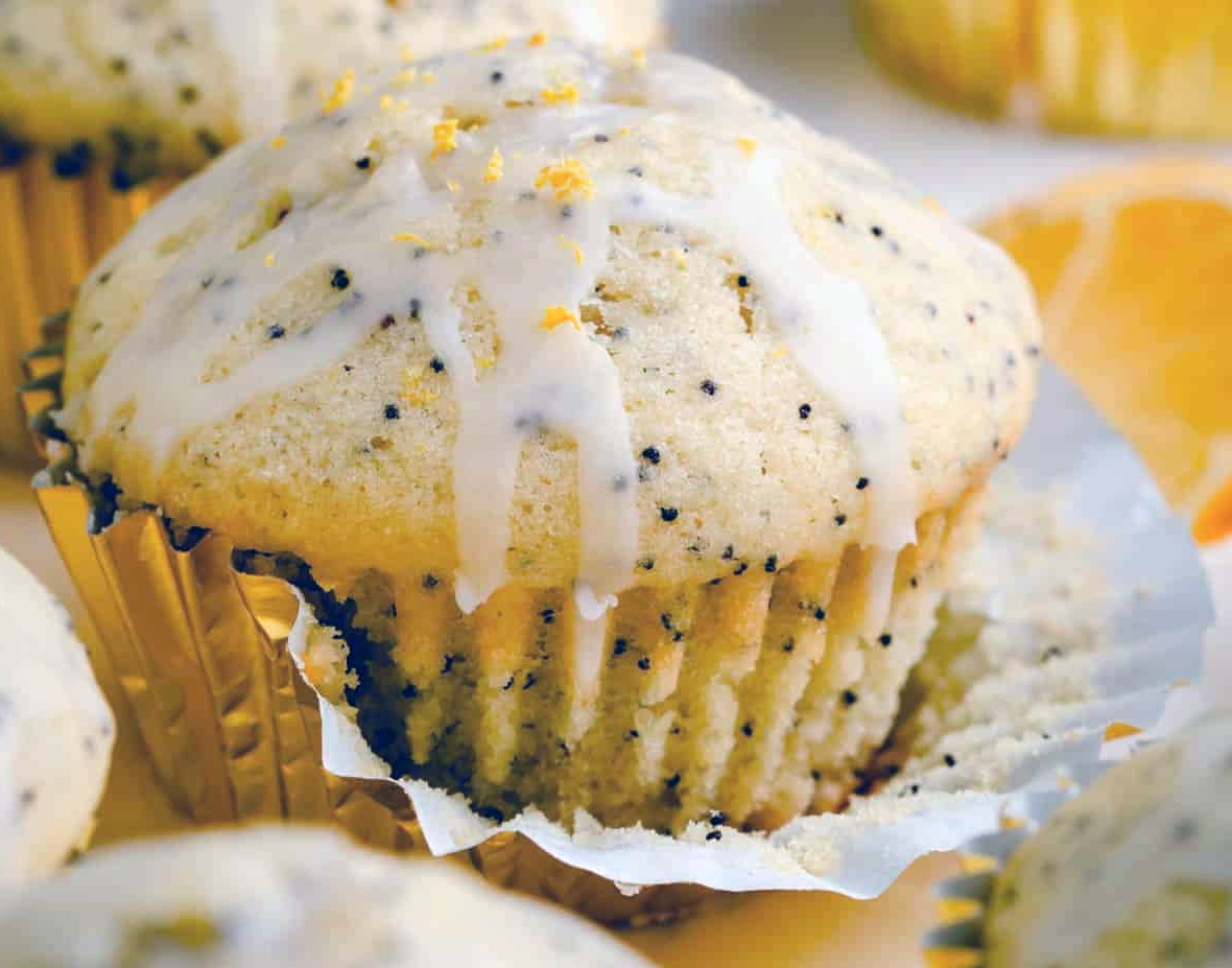st clements poppyseed muffin with marmalade glaze with paper case partially removed
