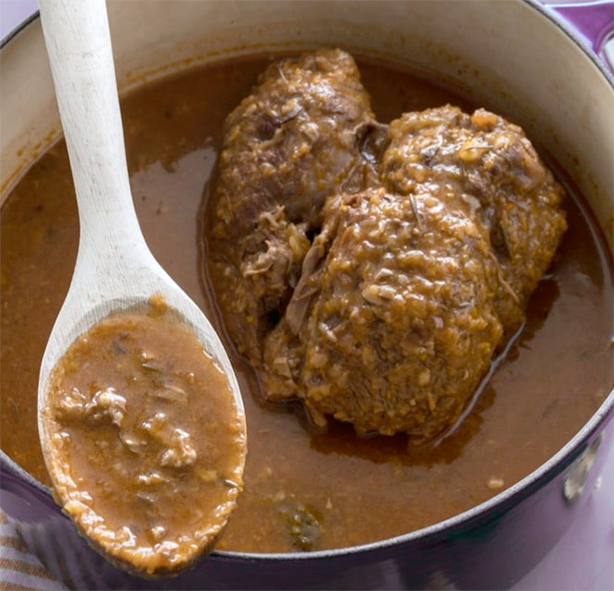 joint of beef in a cast iron casserole with tocco sauce