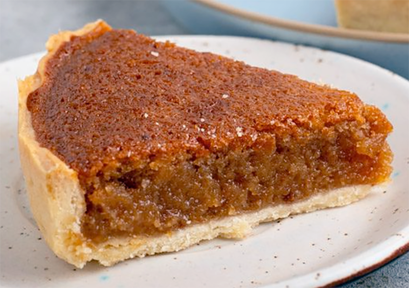 slice of treacle tart presented on a plate