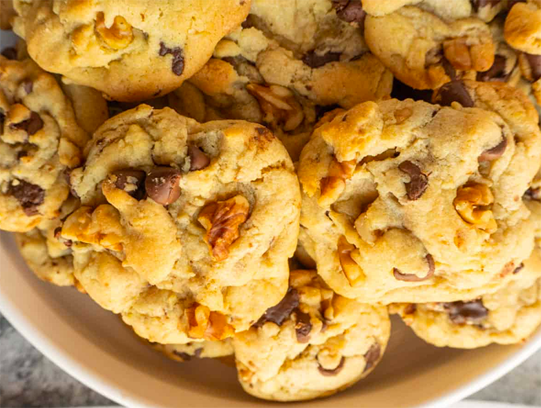walnut and chocolate chip cookies arranged on a plate