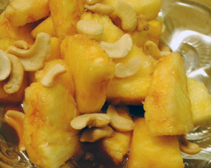pineapple chunks macerated in port wine served topped with cashew nuts
