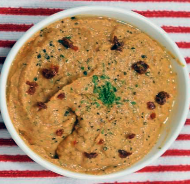Maltese arjoli dip in a bowl garnished with chilli flakes and copped flat-leaf parsley