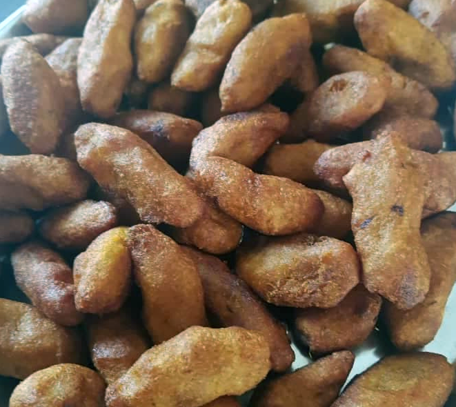 cassava fritters piled on a white plate