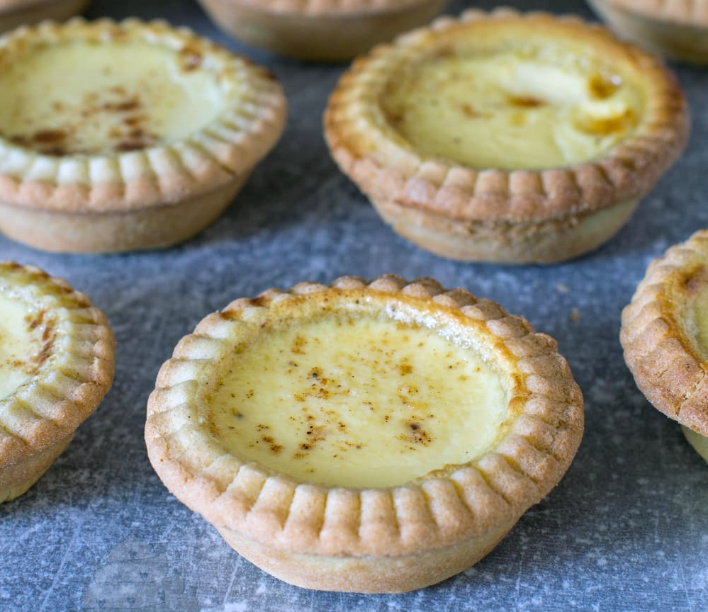 Irish belem tarts of custard in a flaky pastry base on a granite work top