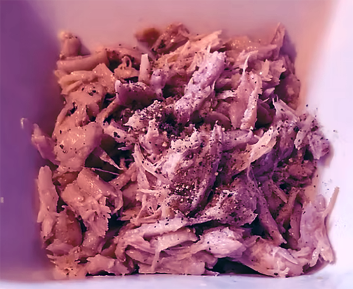 boiled and lightly mashed evening primrose roots in a white dish