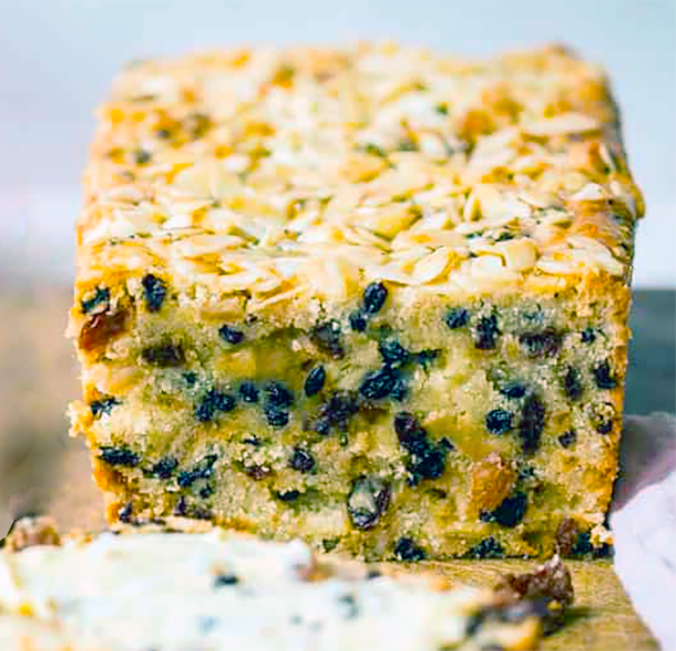 vinegar loaf cake sliced in half to reveal the curranty centre