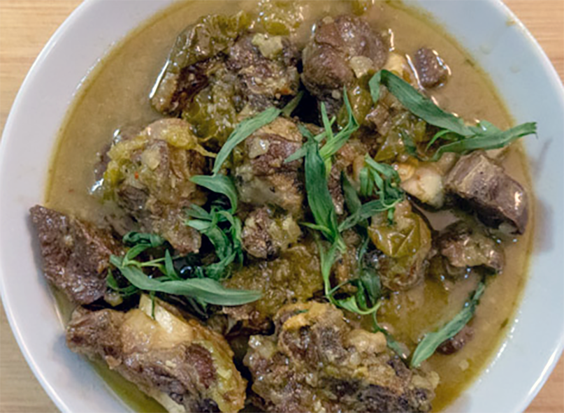 chakapuli lamb stew served in a bowl garnished with tarragon leaves