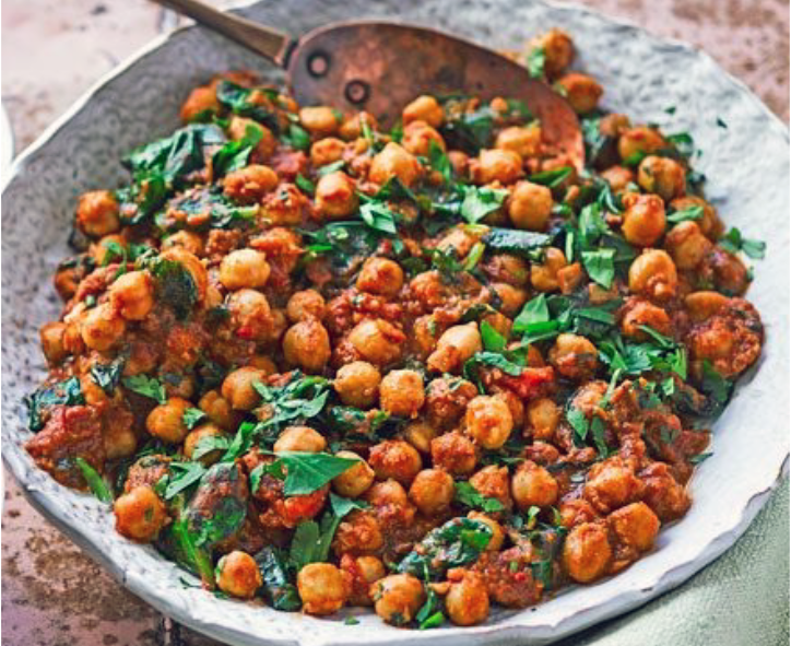 Chickpea curry garnished with coriander leaves served in a bowl