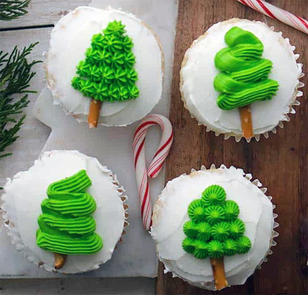 four chocolate cupcakes decorated with glace icing and royal icing christmas trees