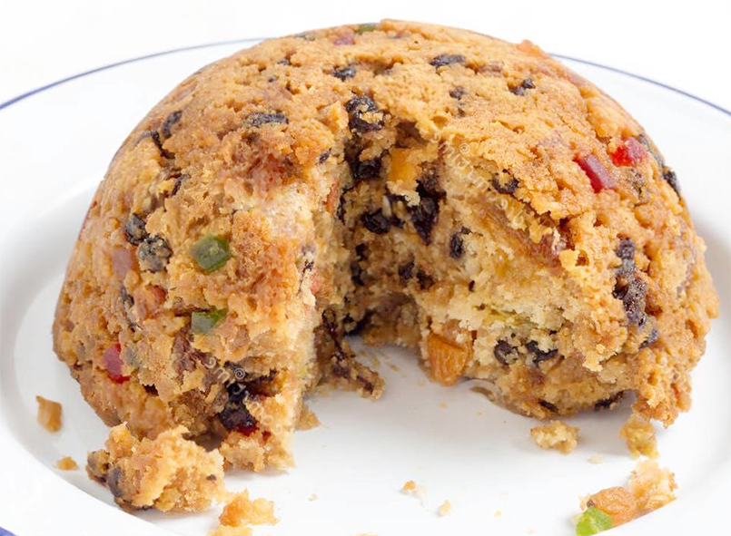 steamed collegiate pudding on an enamel plate
