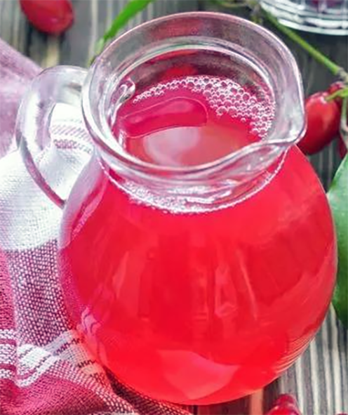 cornelian cherry juice in a glass jug
