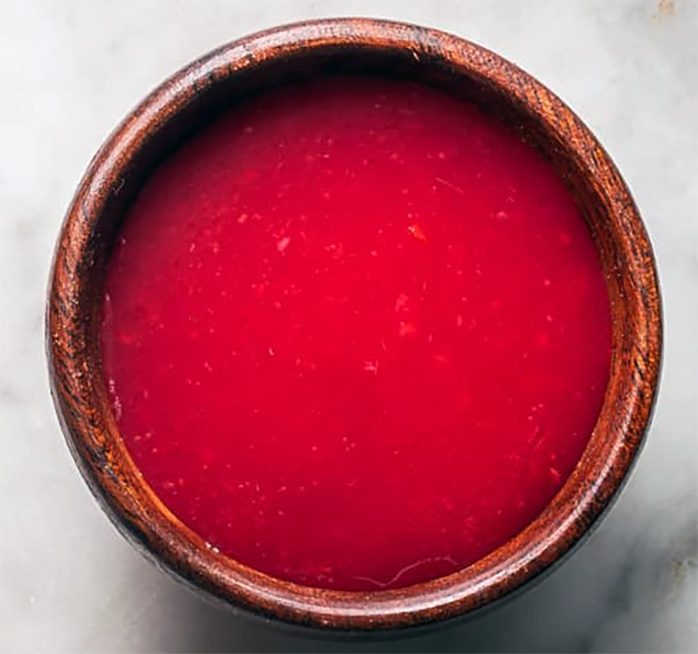 Cranberry hot sauce served in a wooden bowl