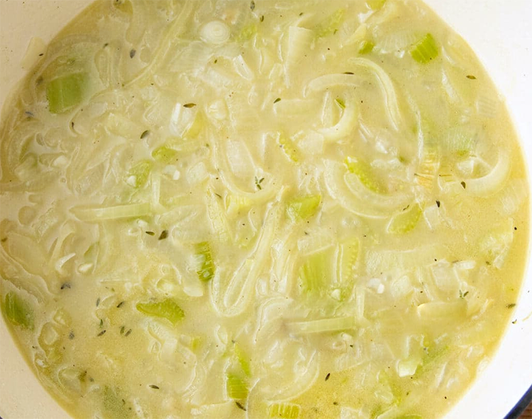 cream of onion soup simmering in a metal casserole