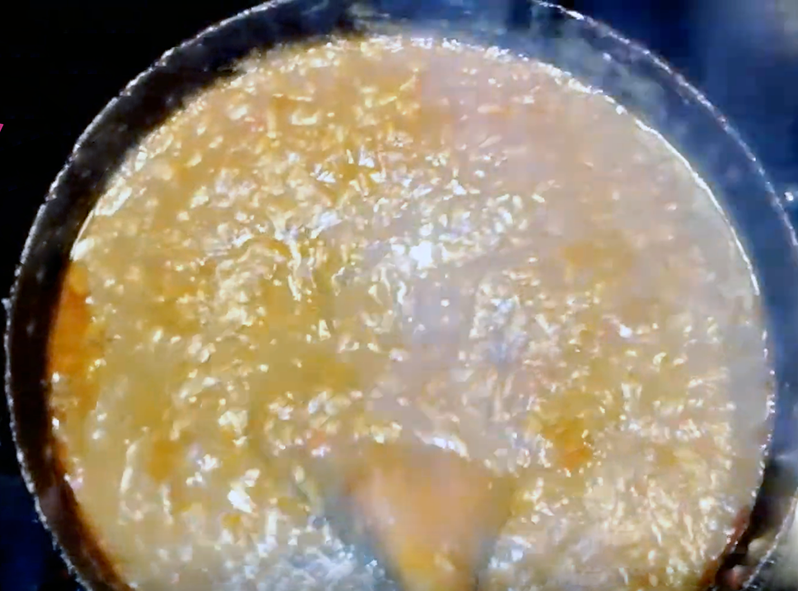 stew of chicken and rice simmering in a dish