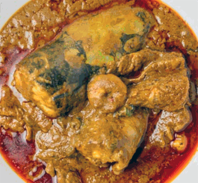 fish stew in a palm soup base served in a white dish