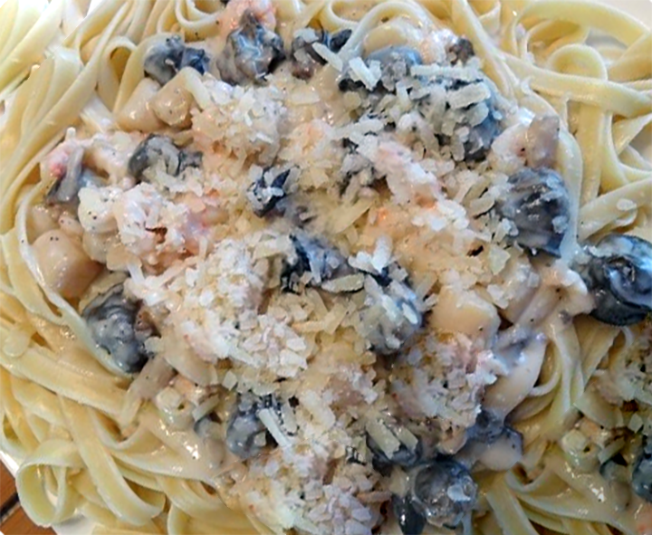 snails in a white sauce served on a bed of fettucine