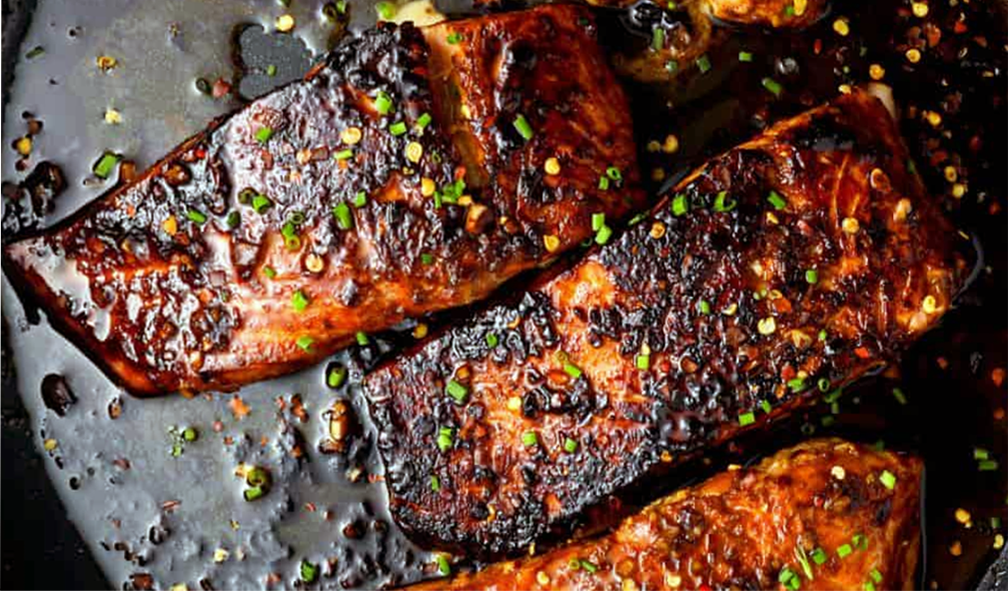 strips of firecracker salmon presented in a cast iron dish