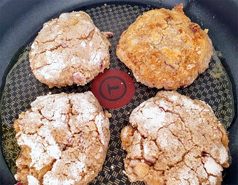 four fonio patties or croquettes in a frying pan