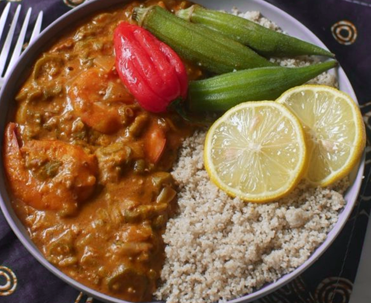 prawns in a peanut and tomato sauce served with steamed fonio and okra