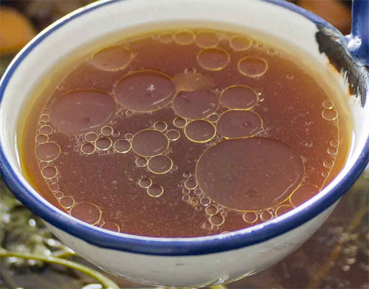 Francatelli's Economical beef stock shown in a ladle