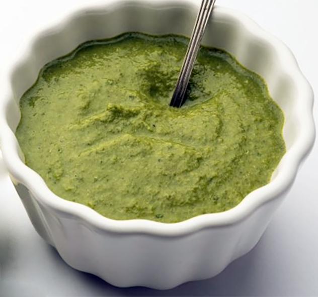 green ravigotte sauce presented in a fluted ramekin