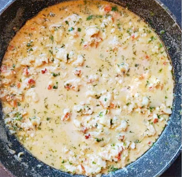 lobster sauce simmering in a deep frying pan