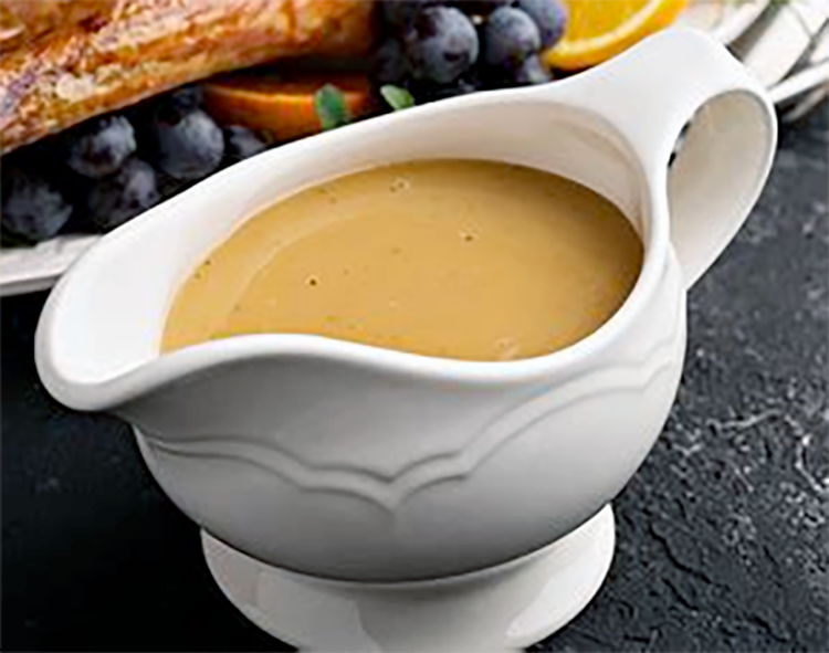 brown richlieu sauce in a sauce boat