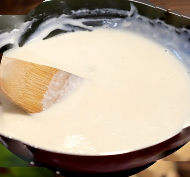 White matelotte sauce stirred in a pan with a wooden spatula