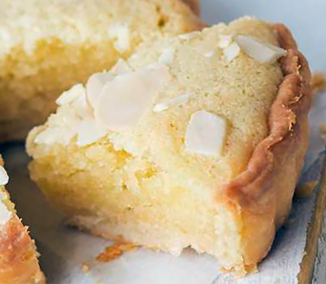Slice of plain frangipane tart removed from the main tart
