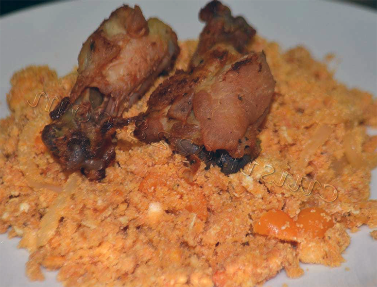 chicken served on a bed of galifoto, scrambled eggs with tomato blended with gari