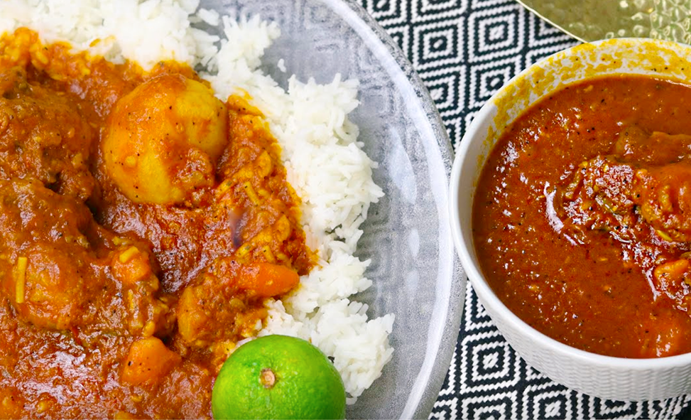 gambian oxtail pepper soup served on a bed of rice with more in a bowl
