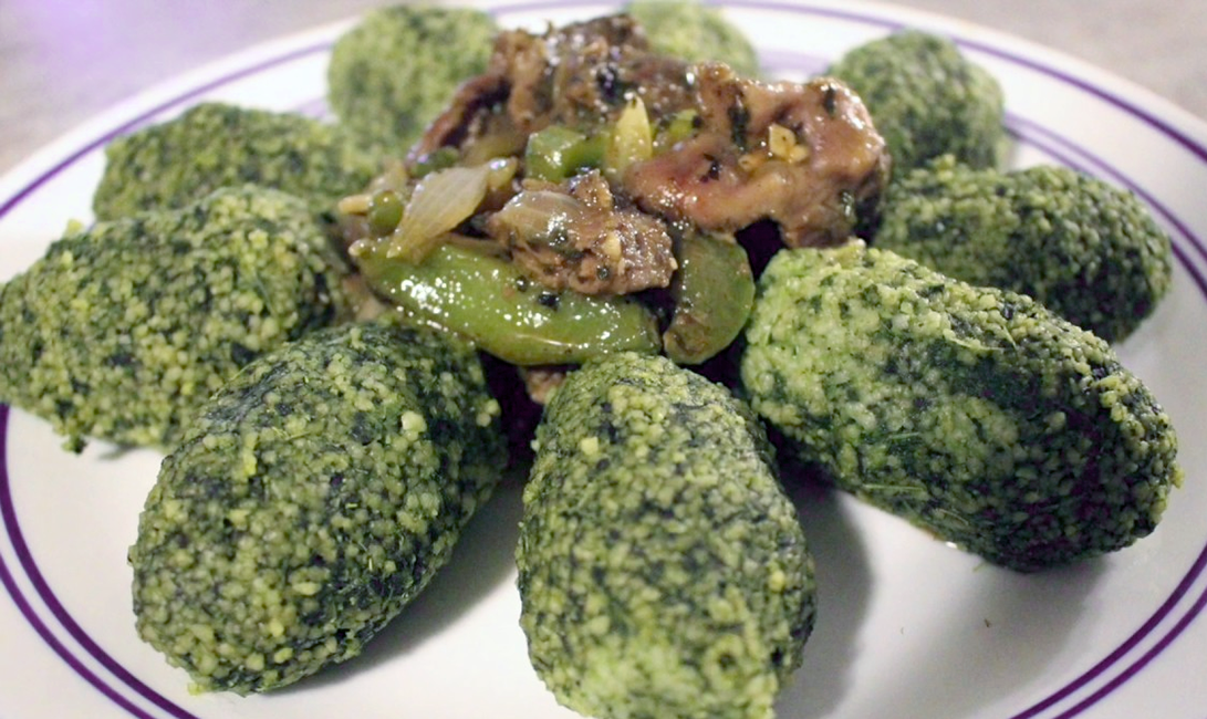 accompaniment of beans and greens served topped with chicken