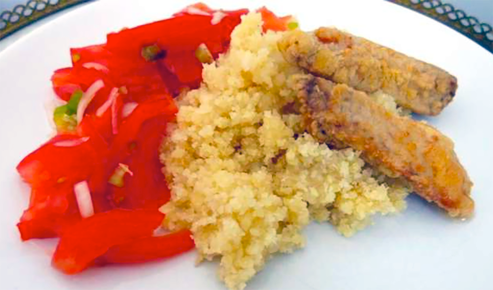 fried floured tuna served on a bed of steamed attieke (cassava couscous) with a tomato, onion and chilli salad