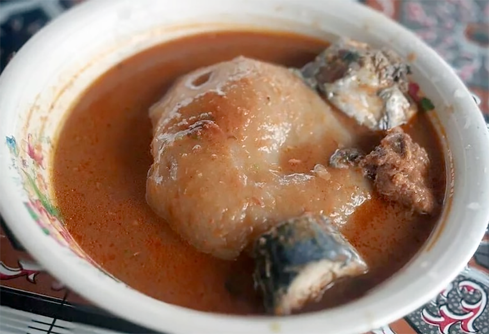 groundnut soup with chicken and fish served in a bowl