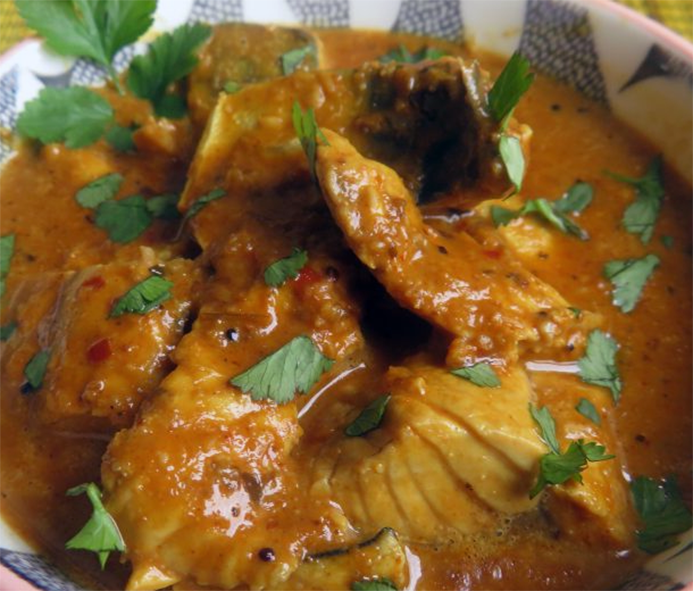 goan mackerel masala with tamarind and coconut served in a bowl with coriander leaves