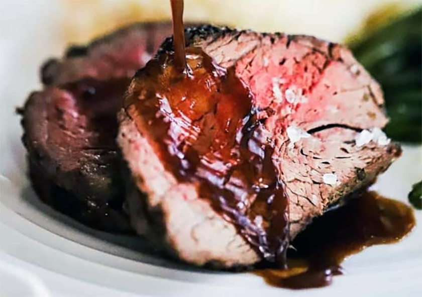 slices of barbecued beef tenderloin drizzled with a red wine sauce