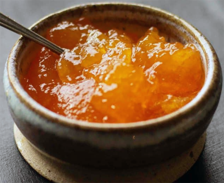 Swedish cloudberry jam in a small pot with a spoon