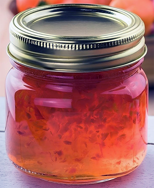 hot pepper rowan and apple jelly in a small glass jar