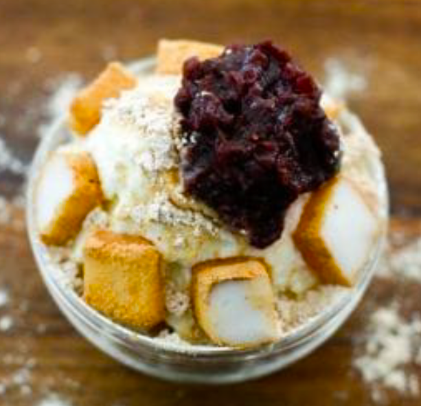 Korean shaved ice dessert served topped with rice cakes and red bean paste