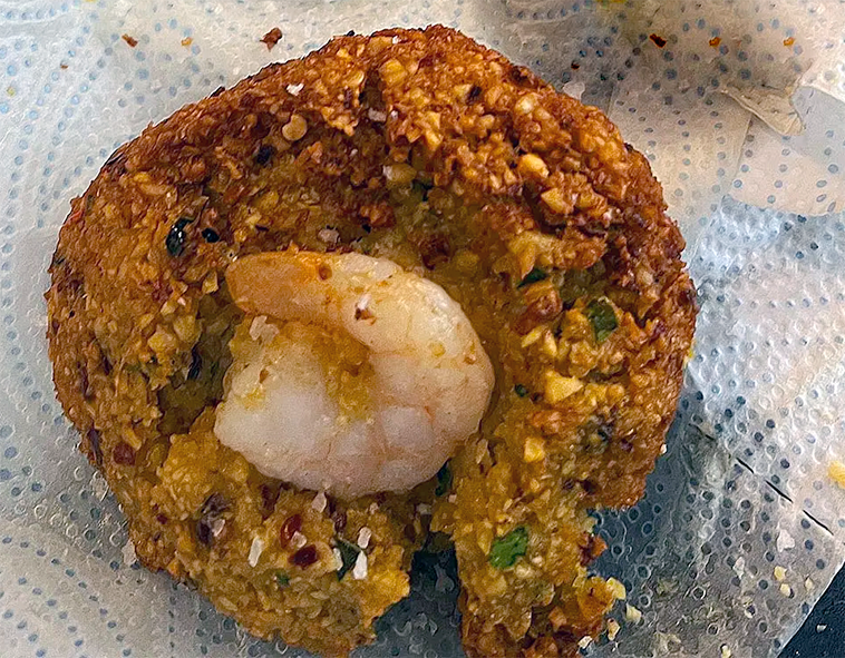 isso vade, split gram lentil patty with prawn topping draining on kitchen paper