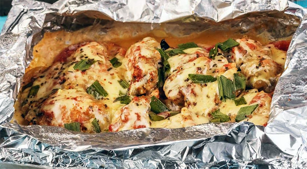jamaican salt fish cooked in a foil parcel with chillies, onions, tomatoes and bacon and served from the foil parcel