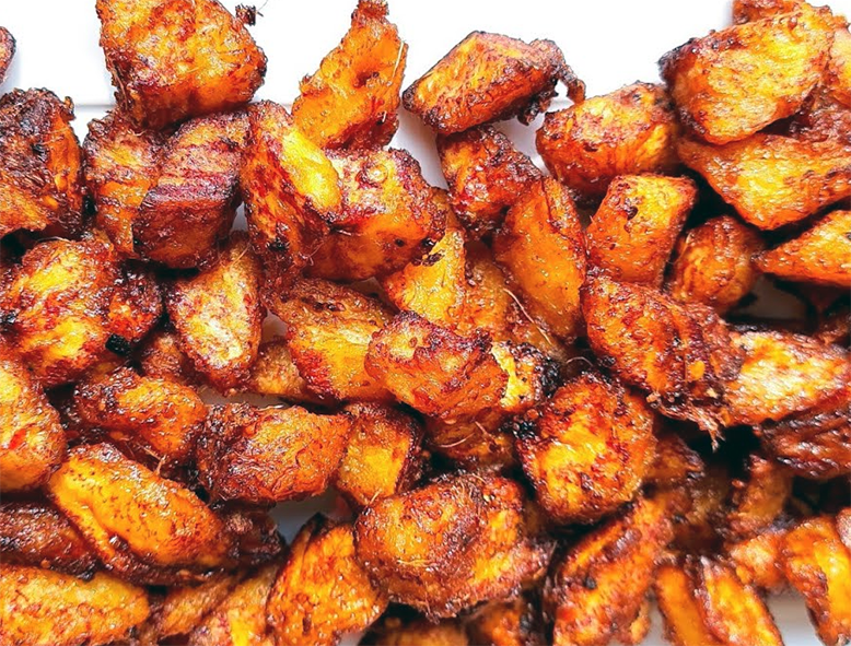 crisp-fried kelewele plantains on a white serving dish