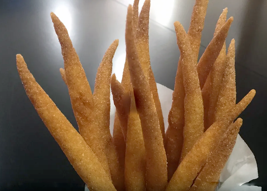 sticks of fried sweetened cornmeal served in a paper cone