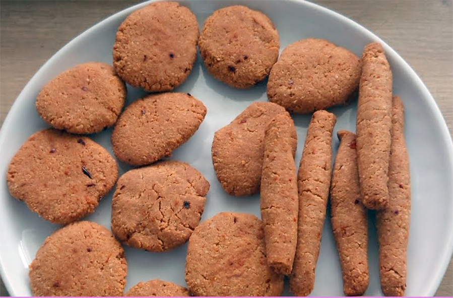 Nigerian kuli kuli, groundnut cakes in rods and rounds arranged on a plate