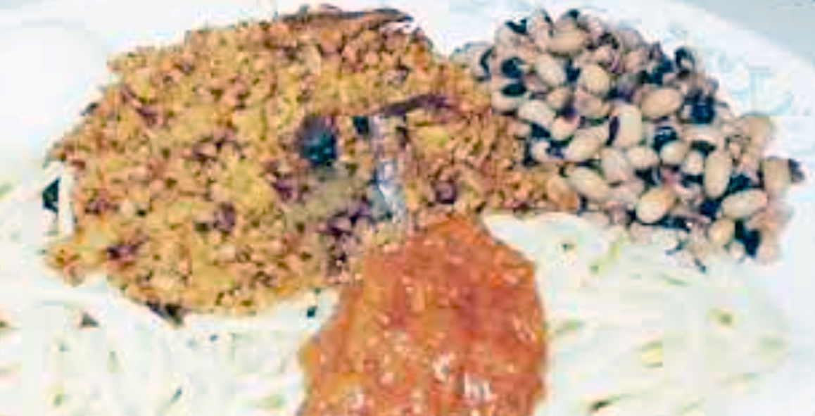 kinkaafa rice served with cowpeas and hot sauce on a bed of long-grain rice
