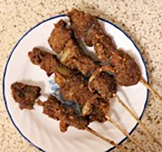 four kyinkyinga kebabs arranged on a plate