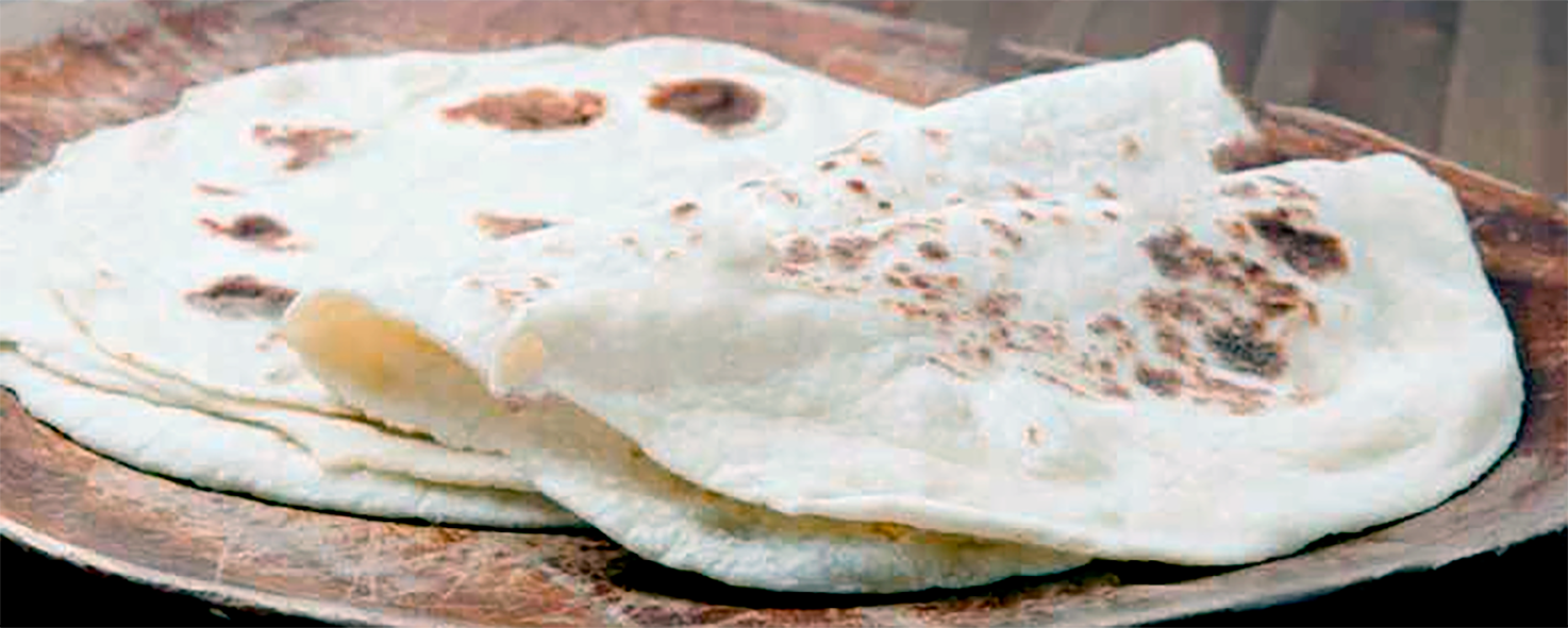 five turkish lavas flatbread shown on a wooden plate with two folded in half