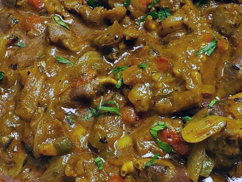 chicken offal and cassava stew in a tomato curry base shown before the addition of chickpeas