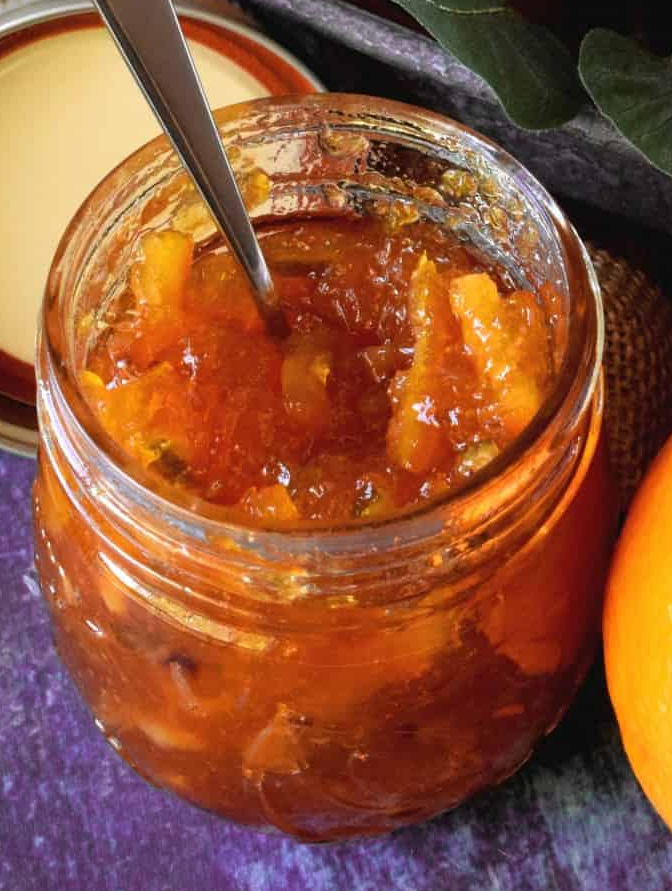 Four-fruit marmalade in a jar with a spoon